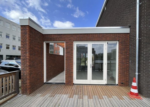 Aanbouw aan eengezinswoning met houten terras en groot raampartij